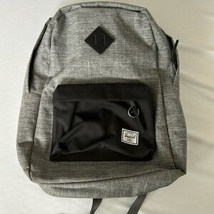 Herschel backpack. Textured grey with black details and red/white stripe inside